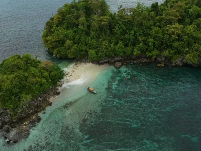 Banggai Islands beach aerial view - Private island with white sand beach, limestone karst cliffs and turquoise lagoon perfect for snorkeling diving Luwuk Sulawesi